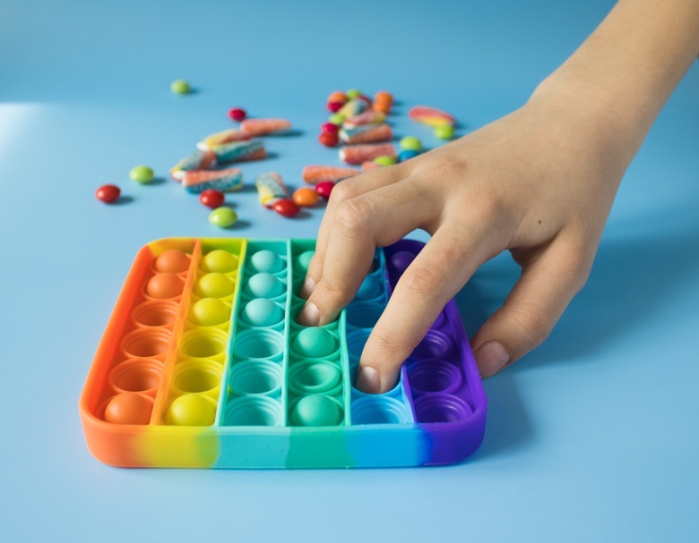 photo of a kid playing with Pop It